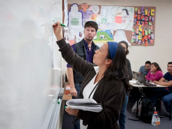 woman writing on whiteboard