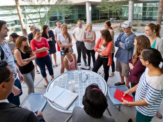 people standing around table