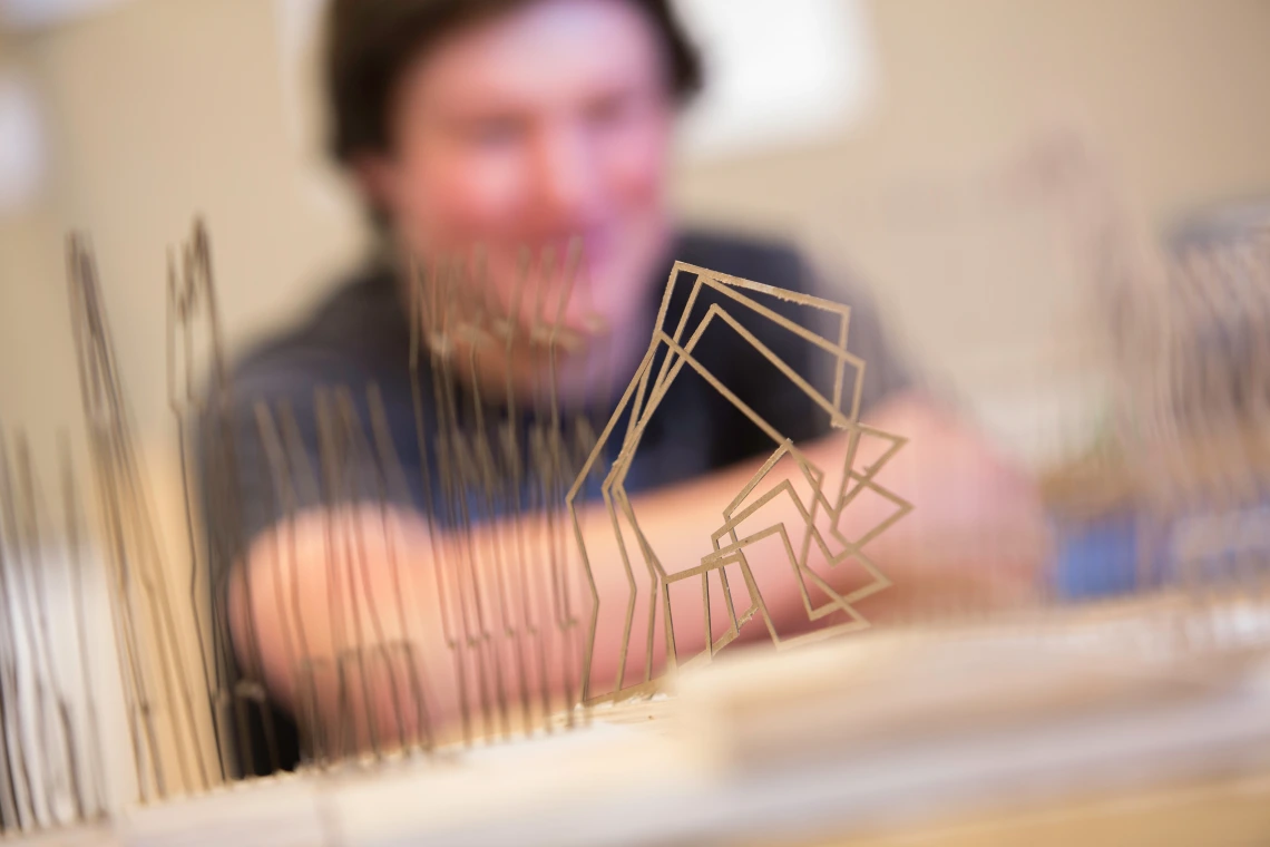 Close up of architectural model with blurred figure in background