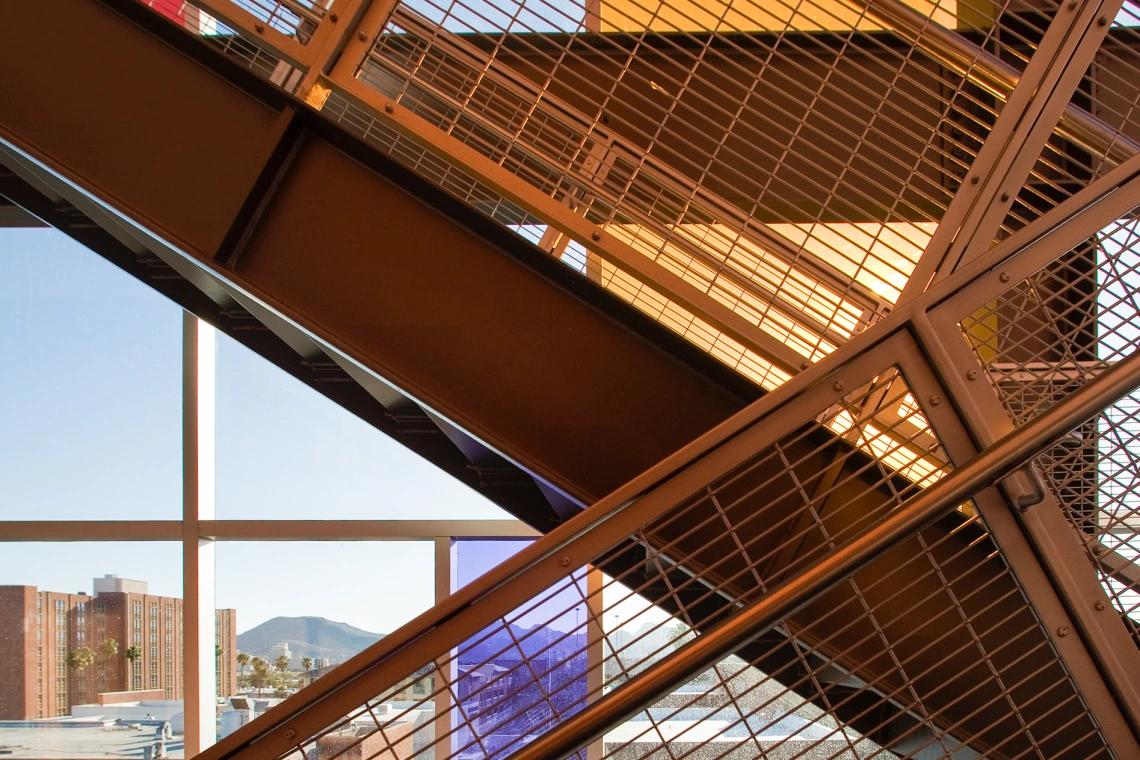 A staircase in front of stained glass.