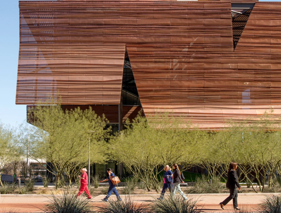 People walking in front of building.